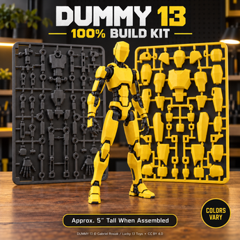 DUMMY 13 100% build kit with a yellow assembled figure, black frame kit card, and yellow armor kit card; approximately 5 inches tall when assembled. Colors vary.