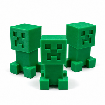 Small green blocky 3D printed clicker fidget toys with pixel-style faces