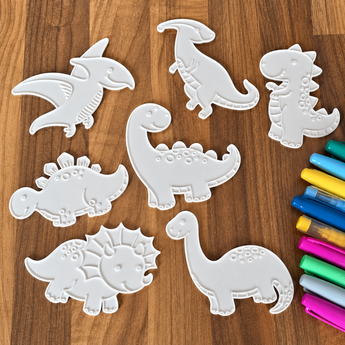 Seven white 3D printed PETG dinosaur coloring pieces with colorful acrylic markers